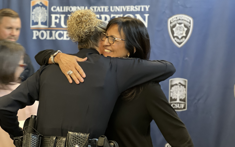 Corporal Hollyfield and ASC employee embrace after recieving lifesaving awards for saving the life of a co-worker