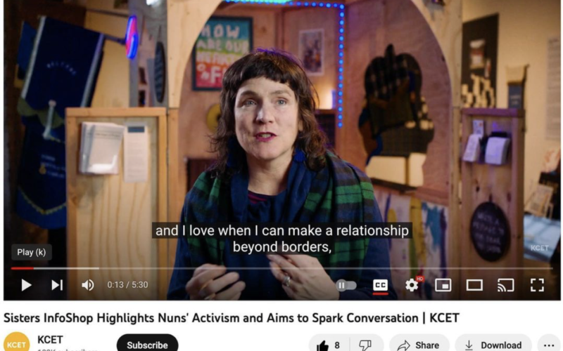 Artist Lex Walsh appear in front of her Sisters InfoShop art installation.