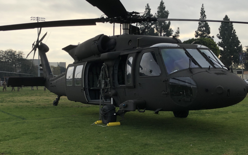 An Army military H-50 helicopter on the lawn of the CSUF Intramural field