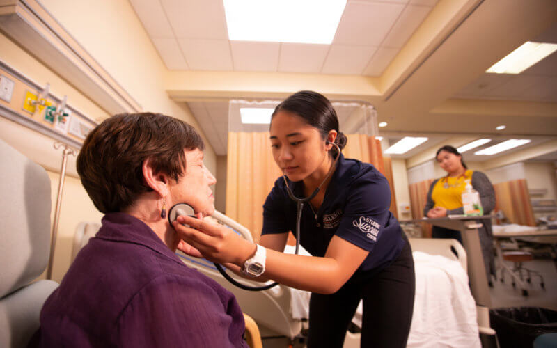 CSUF Nursing Student working with patient
