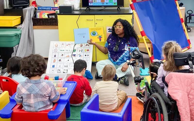 Ainara Johnson in Classroom reading to children