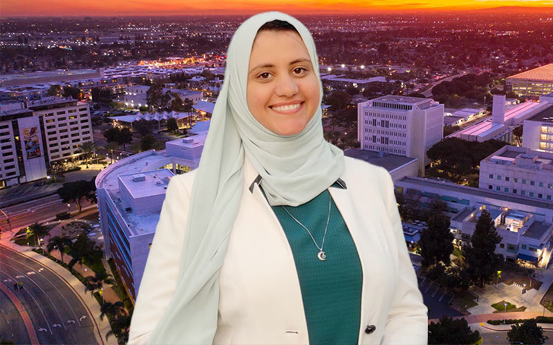 Headshot of Dina Saad. She is photoshopped over an aerial image of the Cal State Fullerton campus at sunset.