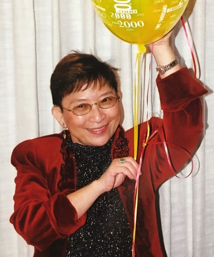 Photo of Veronica T. Chiang, smiling and holding a balloon.