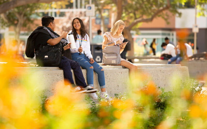 High school friends Willy Reyes, left, and Brandy Gil, right, reunite on their first day of college.