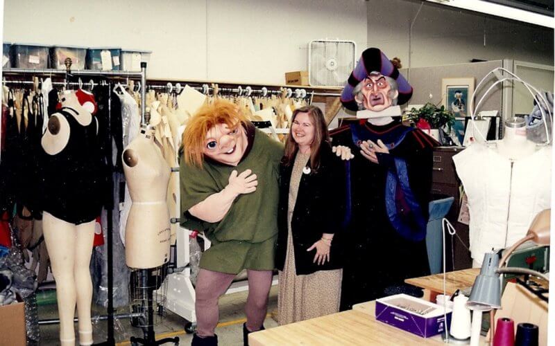 Karen Weller poses with characters at the Disneyland Resort