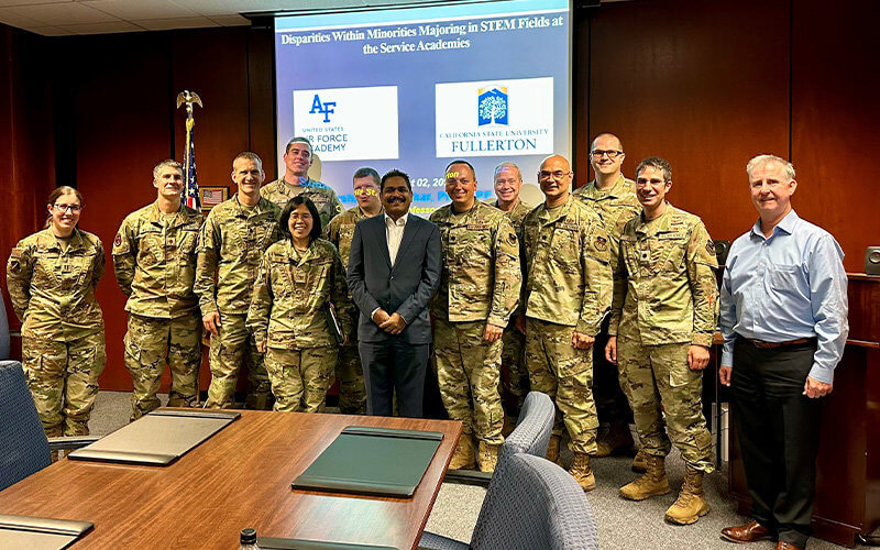 Sudarshan Kurwadkar posing for a photograph with the U.S. Air Force Academy faculty members