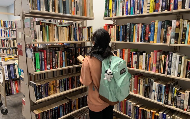 Student browsing books at the Book Sale Center.