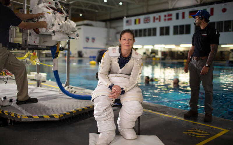 NASA astronaut Tracy Caldwell Dyson pauses for a portrait while donning her spacesuit and going under water in the Neutral Buoyancy Lab, Monday, July 8, 2019 at NASA's Johnson Space Center in Houston, Texas. Photo Credit: (NASA/Bill Ingalls)