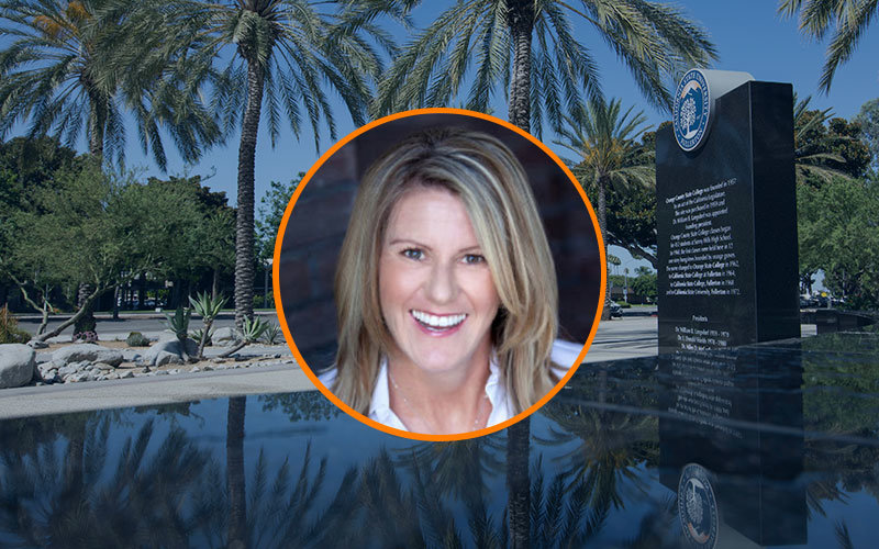 Circular image frame outlined in orange of Dr. Loretta Donavan. Behind the circular frame is a background image of the fountain and palm trees in front of Langsdorf Hall on the CSUF campus.