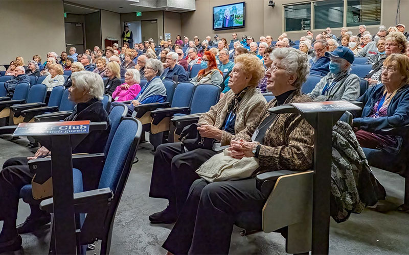 Large group of active older adults sitting in the auditorium at Ruby Gerontology Center.
