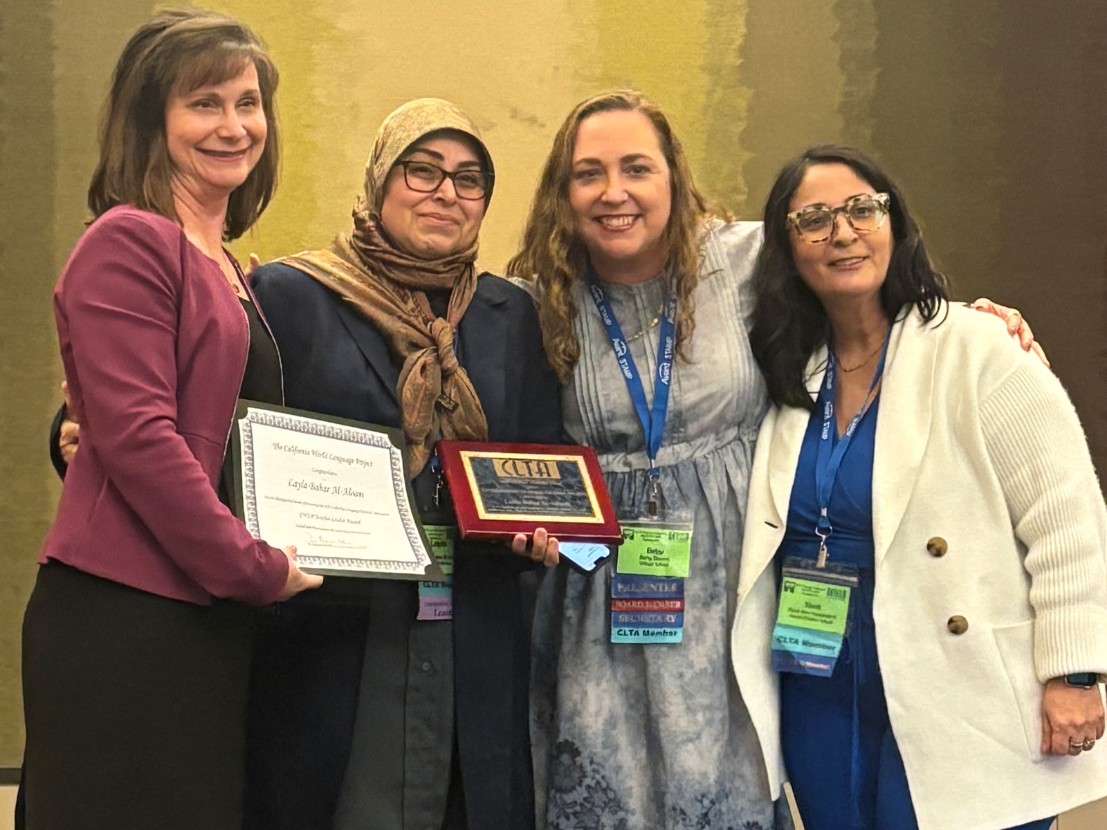Dr. Bahar Al-Aloom poses with colleages after being awared the CLTA Outstanding Teacher Leader Award