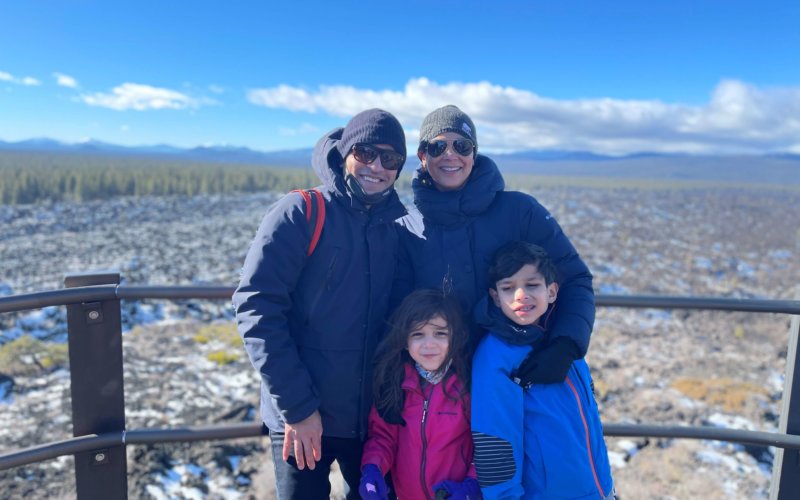 IMAGE OF ABEL NAVARRETE, VP OF COLUMBIA SPORTSWEAR, WITH FAMILY: TWO CHILDREN AND SPOUSE, ON WINTERY VACATION