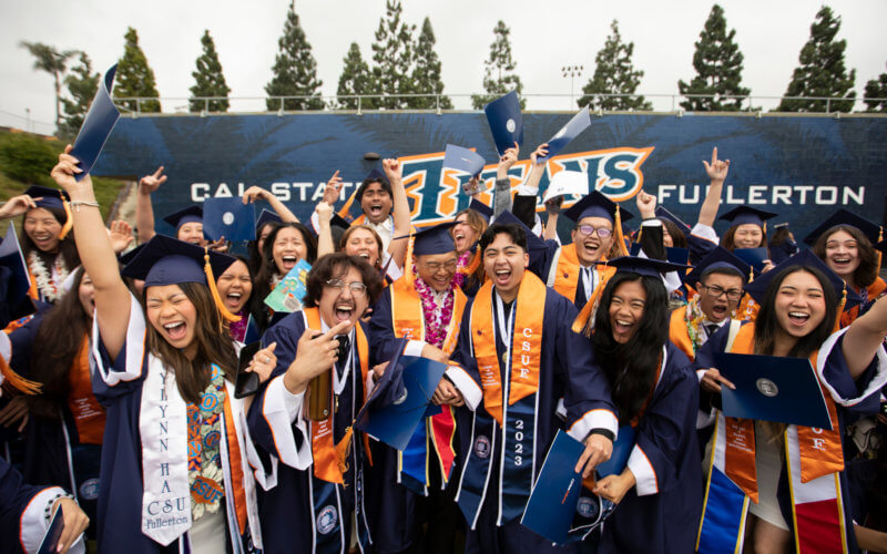 graduates celebrating at Cal State Fullerton's commencement ceremony