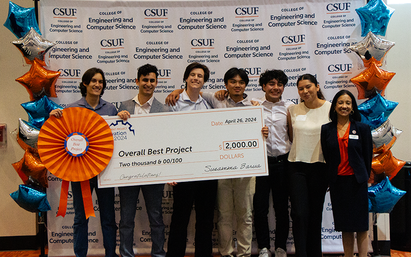 Winning student team at the ECS Student Project innovation Expo poses with Dean Susan Barua