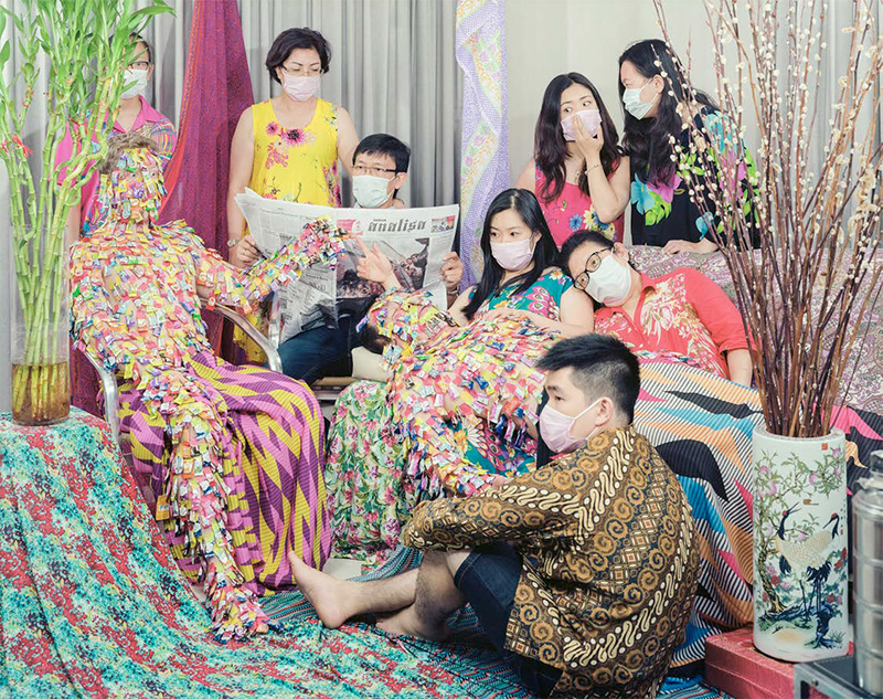 Nine men and women wearing masks.