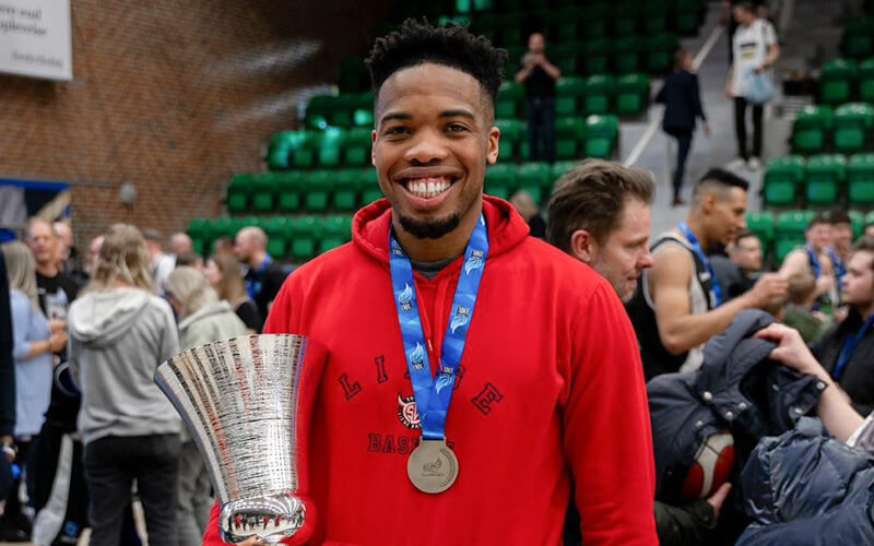 CSUF MBA student and professional basketball player E.J. Anosike celebrates victory with Liege in Belgium.