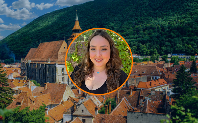 Circular image frame outlined in orange with a headshot of Jessica Ryan. Behind the frame is a background image of Romania.