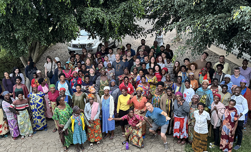 Group of men and women under trees.