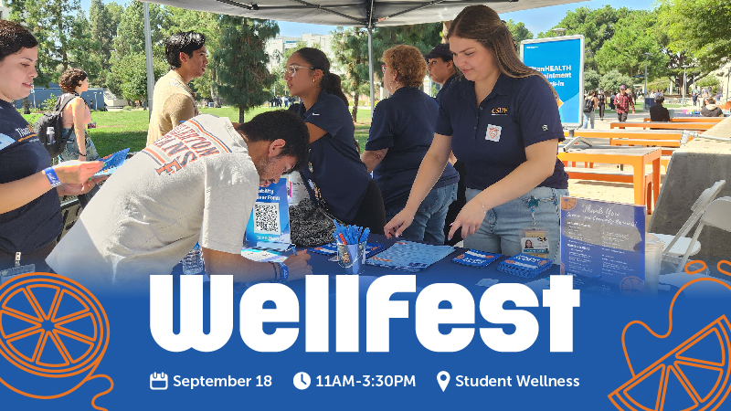 Students working an outreach event outside.