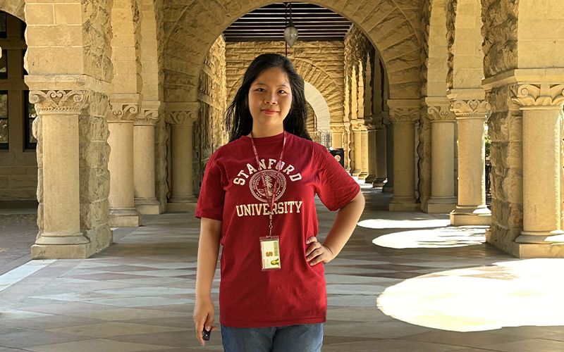 Sally Dinh at the Memorial Church, wearing a red Stanford University t-shirt.