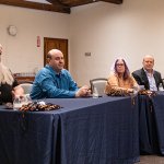 Four faculty members sitting at a table for a panel discussion