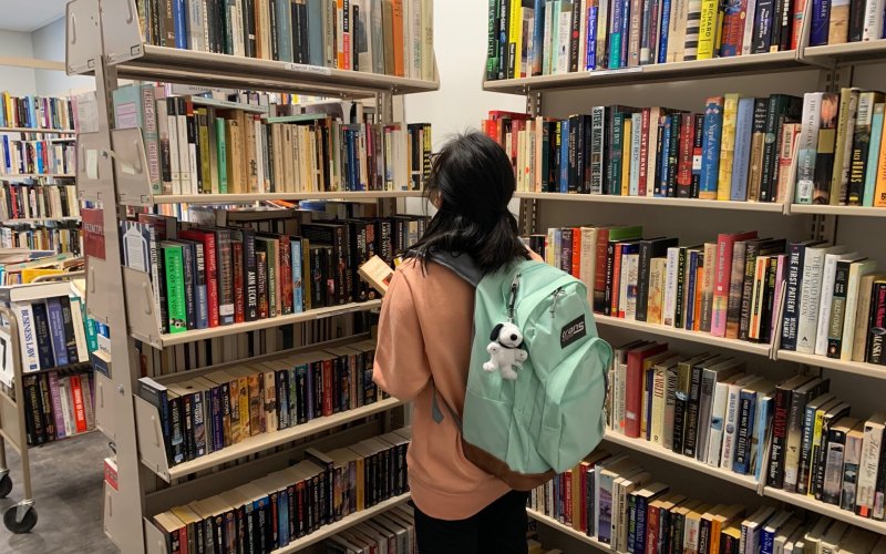 One student browsing the books at the Book Sale Center.