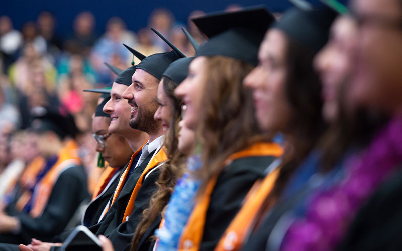 CSUF students at Commencement wearing graduation regalia.