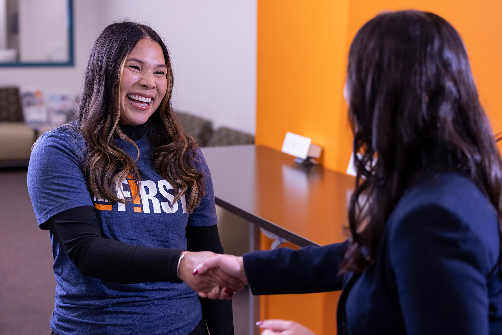 Lizeth Fuentes shakes hand with Elizabeth Zavala