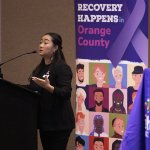 Nina Tran, a health educator for Titan Health, speaking at a podium in the Titan Student Union during the Feb. 5 opioid crisis town hall event at Cal State Fullerton