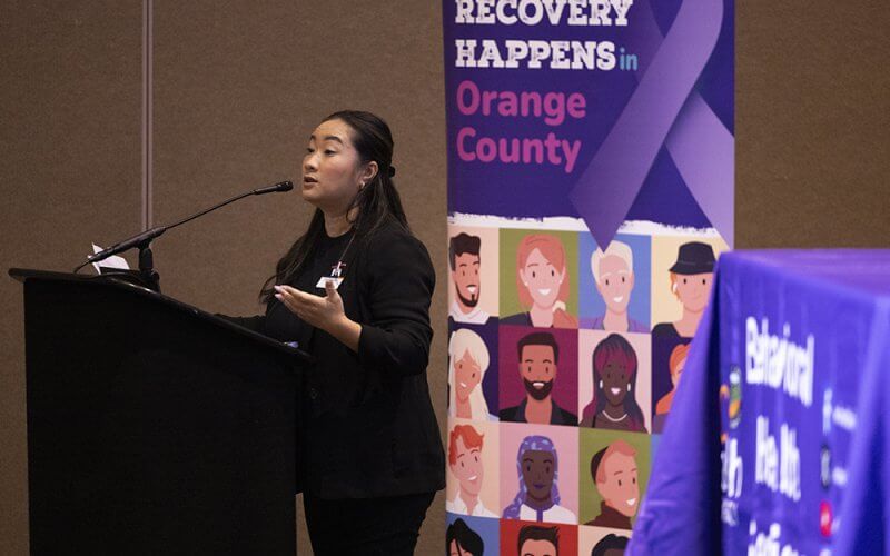 Nina Tran, a health educator for Titan Health, speaking at a podium in the Titan Student Union during the Feb. 5 opioid crisis town hall event at Cal State Fullerton