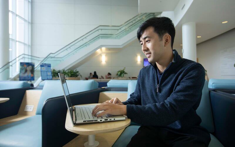 Dylan Ohashi, aspiring public accountant, works on laptop