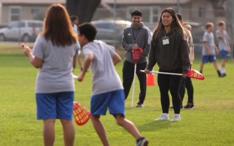 CSUF kinesiology students teach Ladera Vista Junior High School students how to play lacrosse.