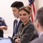 CSUF student Crystal Weber sits at a table during a student researcher panel