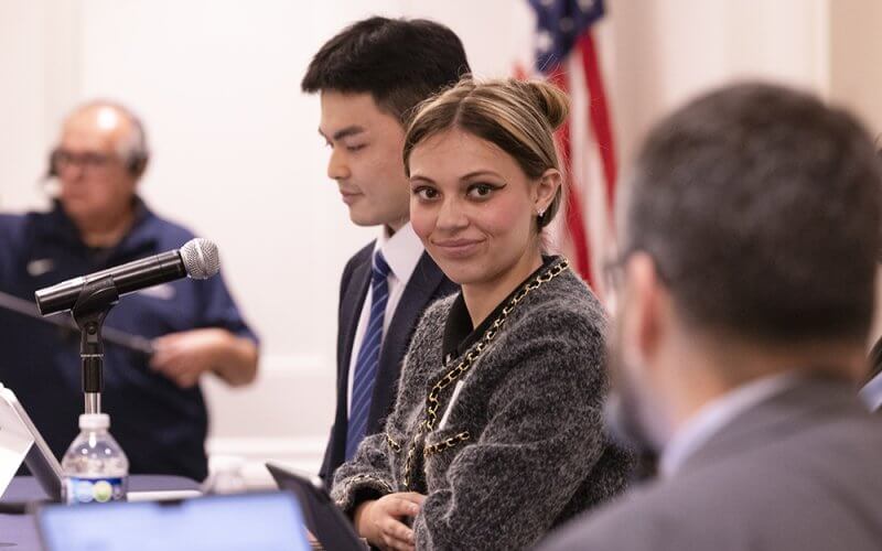 CSUF student Crystal Weber sits at a table during a student researcher panel