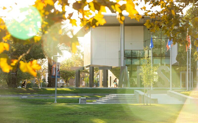 Titan letters are shown in front of Cal State Fullerton's Titan Student Union during autumn.