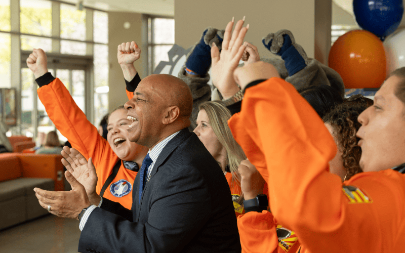 President Rochon and CSUF staff cheer in celebration of Titans Give at campus event