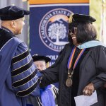 President Ronald Rochon congratulates Martha Blanding