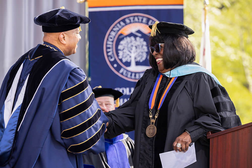 President Ronald Rochon congratulates Martha Blanding