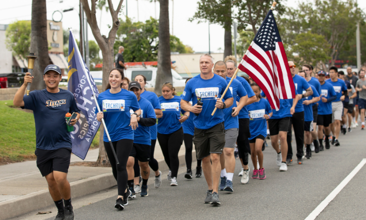 CSUF police officers in blue Special Olympics shirts run with CSUF student-athletes in support of the Law Enforcement Torch Run to support the Special Olympics.