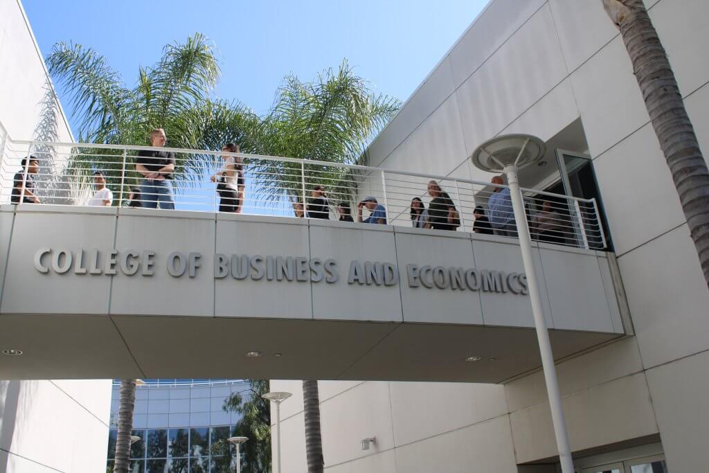 A group of people visit the CSUF business and economy. 