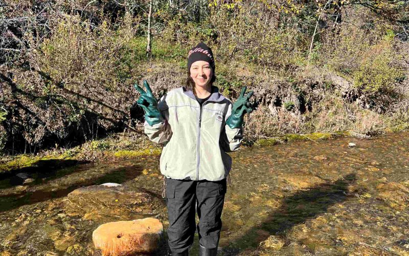 Alexis Ortiz collects a water sample.