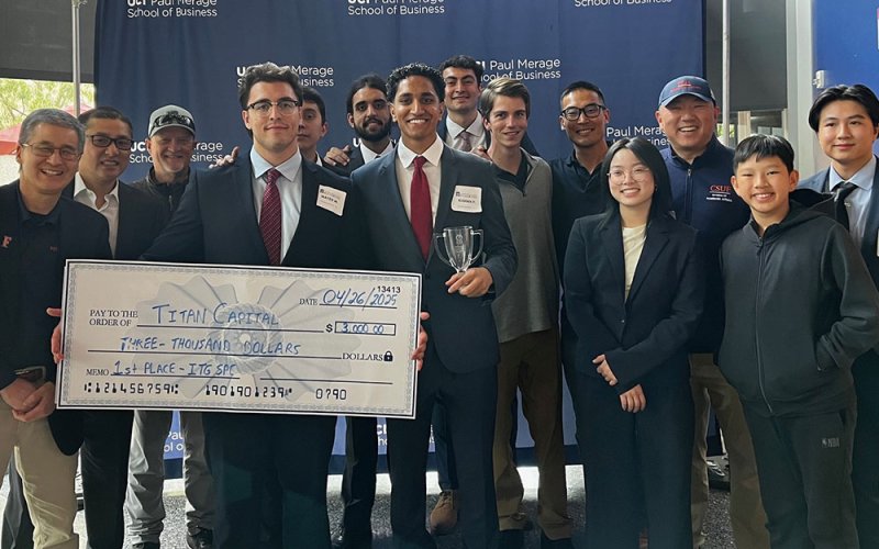 CSUF Titan Capital Management students hold a large check for $3,000 at the Irvine Investment and Trading Group Stock Pitch Challenge.