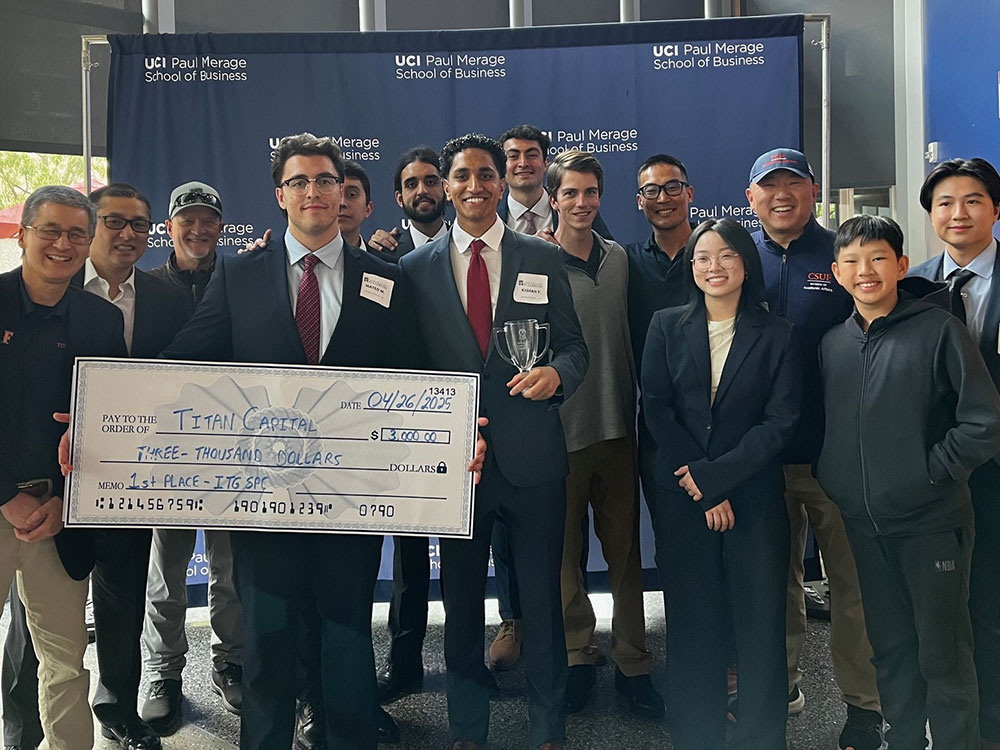 CSUF Titan Capital Management students hold a large check for $3,000 at the Irvine Investment and Trading Group Stock Pitch Challenge.