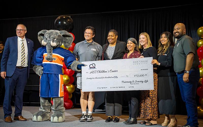 CSUF Fraternity and Sorority Life present a large check to the ASI Children's Center at the Tuffy Awards.