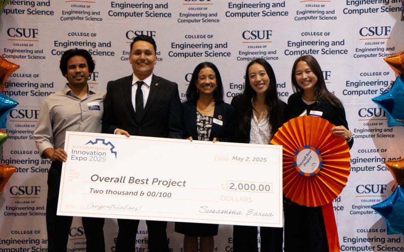 Four students pose with former ECS Dean Susan Barua after winning the 2025 ECS Expo