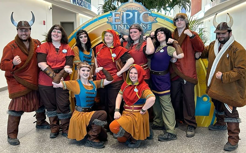 A group of employees in costume at Epic Universe