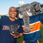 CSUF President Ronald Rochon and Tuffy pose for a photo on the field at Angel Stadium.