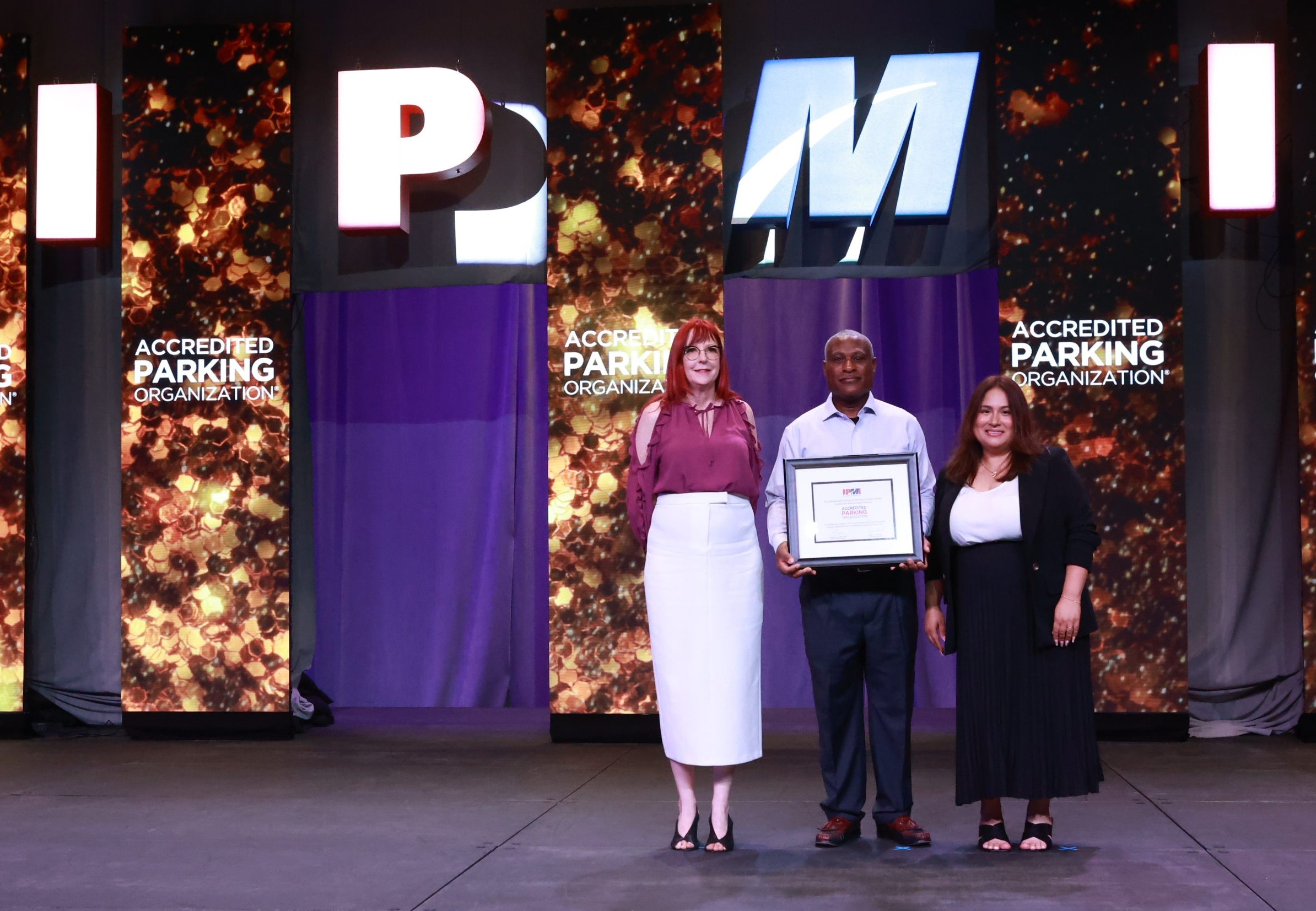 Elissa Thomas, Reggie Turnbow, and Monica Chavez accept the IPMI accreditation plaque.