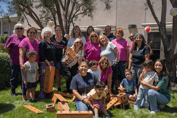 Members of the Women's Club of Fullerton deliver playing blocks to children at the ASI Children's Center.