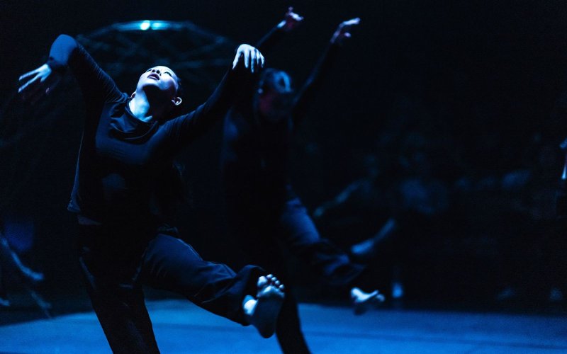 Dancers perform on stage.